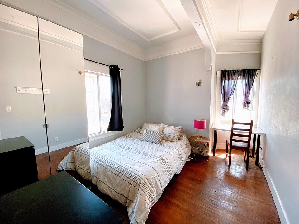 Room 1, furnished with Queen Bed and desk
