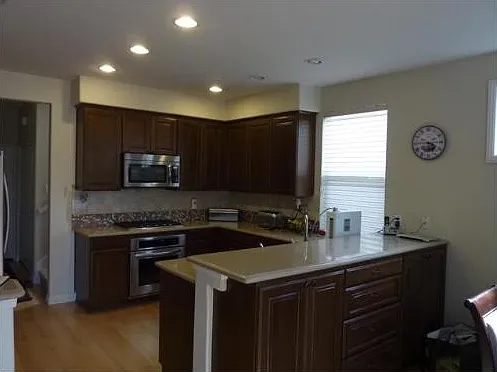 Kitchen with previous flooring. All of the bottom floor has LVP flooring as shown in family room picture