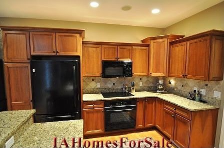 Kitchen - granite counter tops, cherry cabinetry, above cabinet accent lighting, tile backsplash, GE Profile appliances