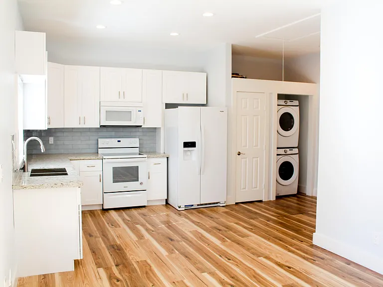 Another view of the beautiful chef's kitchen. Brand new washer and dryer in accessible area for convenience.