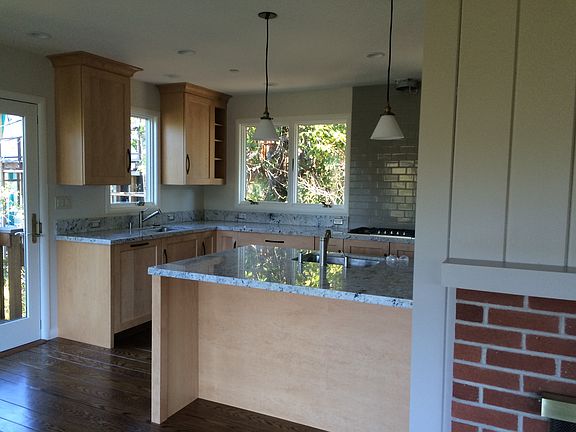 Kitchen opens to living room with a dining bar.