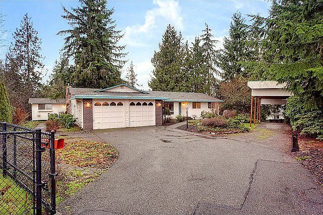 Wonderful home with gated, secured entry, beautiful landscaping and covered RV parking on the right.