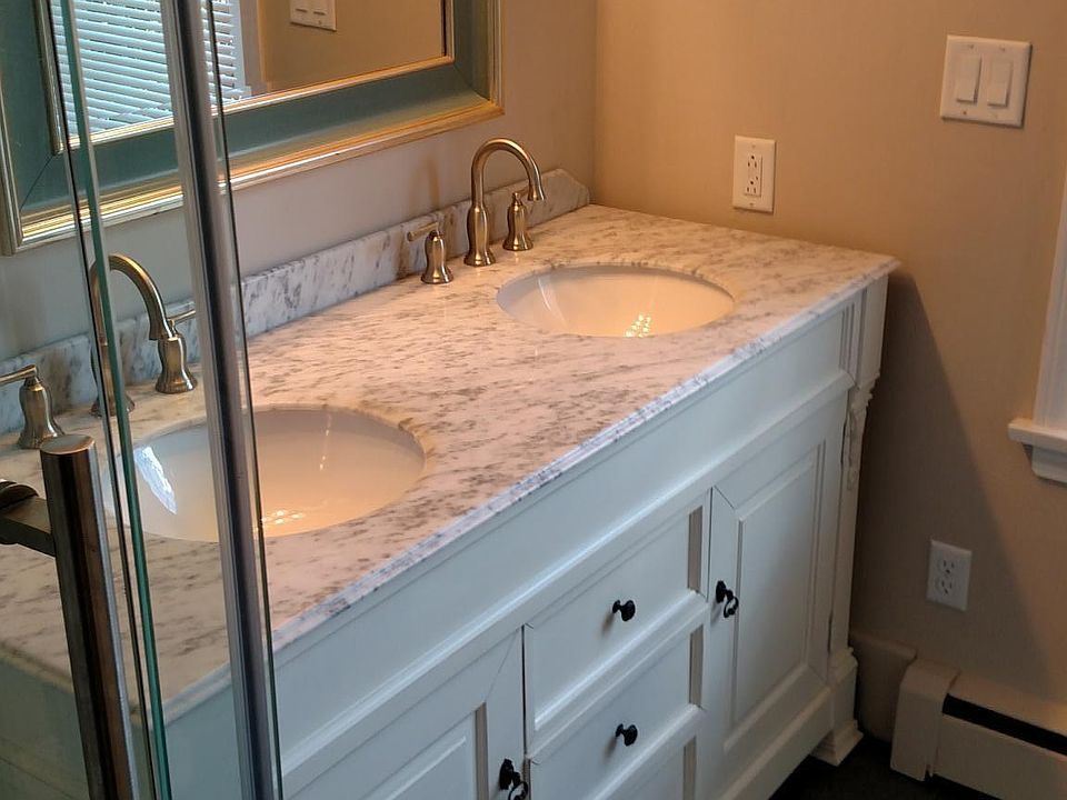 Updated ensuite with double Carrera marble vanity.
