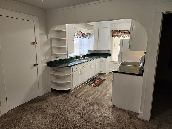 Kitchen. Door near kitchen leads to back porch containing washer/dryer hookup and furnace. Off of back porch is an exterior door leading to deck.