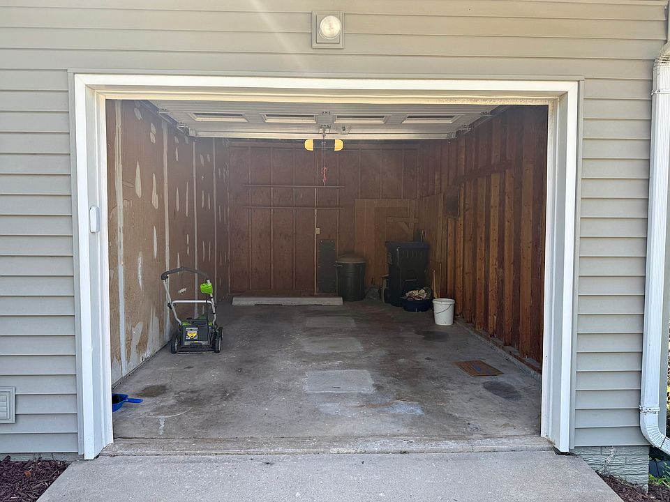 One-car attached garage with included lawn mower and extra storage space