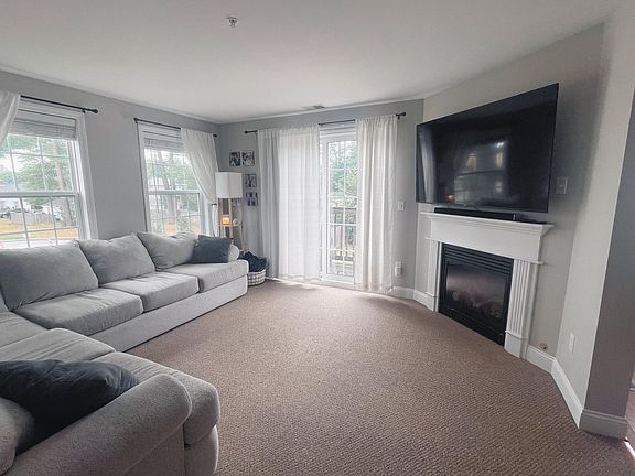 Living Room with gas fireplace and small deck