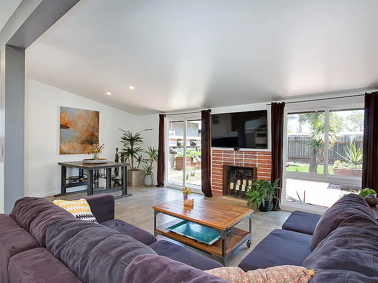 Expansive living space. Television mount & all window coveri