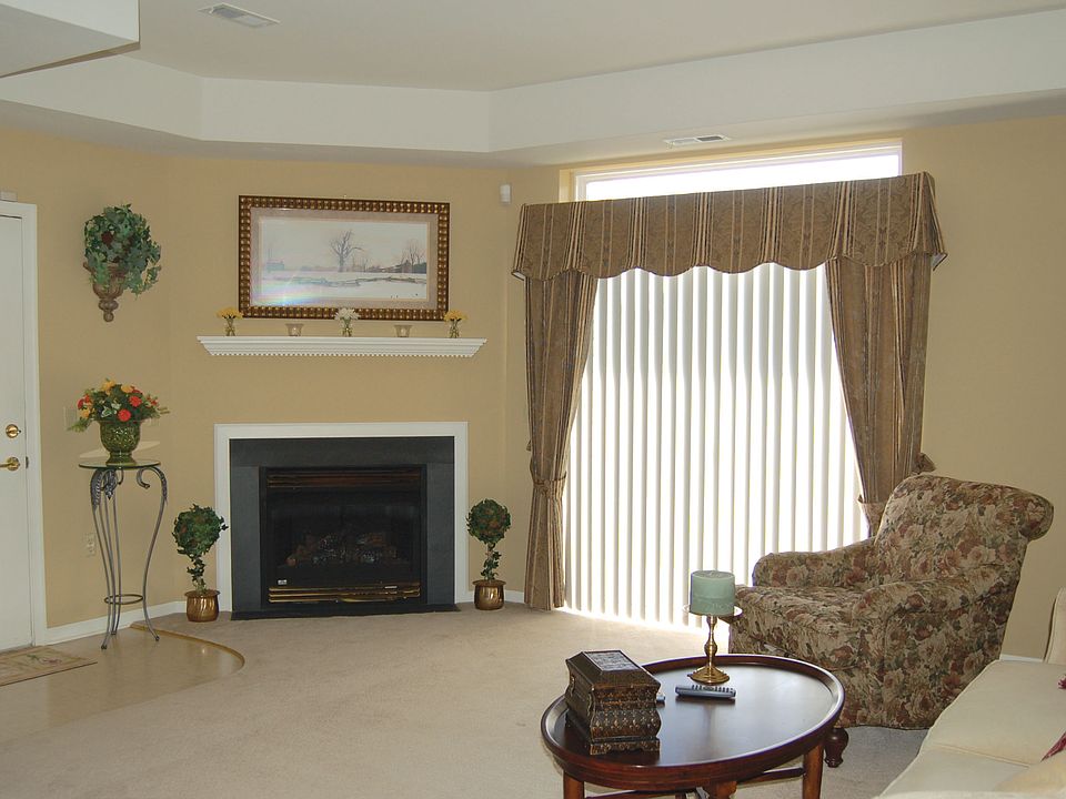 Living Room with fireplace & sliders to patio