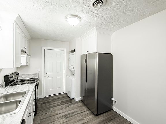 Eat-in kitchen and back door from beside doorway to living room