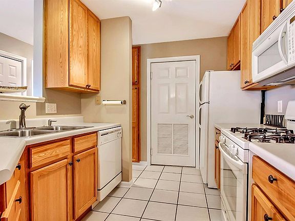 KITCHEN WITH CERAMIC FLOORING & APPLIANCES....NOTICE THE PANTRY CABINET IN THE BACKGROUND