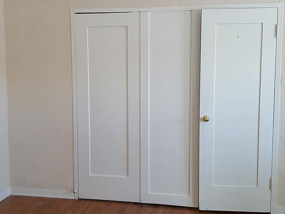 Living area showing entry to closet, vanity, and bathroom