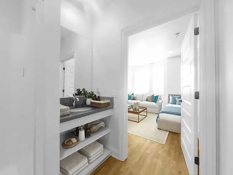 Large bathroom with walk-in shower and ample storage.