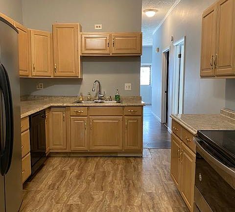 Walk though front door, through first living room. Beds on left, bath on right. Hallway opens to kitchen.