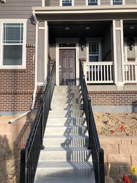 Front steps face West - across from kid's playground, dual railings