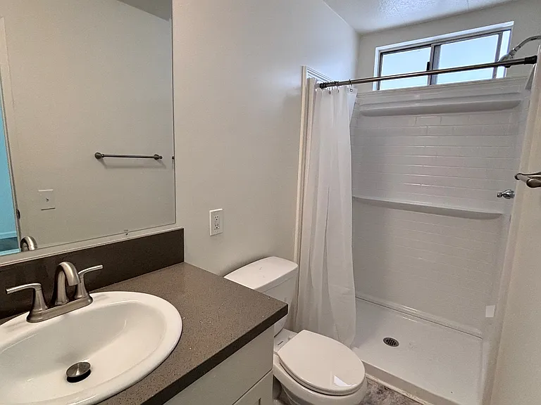 _ The primary bathroom offers a private, well-appointed space designed for both comfort and convenience. Featuring a functional layout with ample counter space and storage, it provides everything needed for a smooth daily routine.
