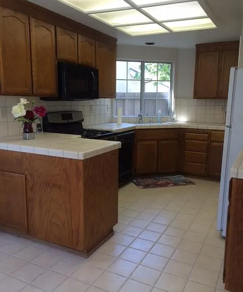 large kitchen with eat in area at bay window...gas range, door to garage, sliding door to patio