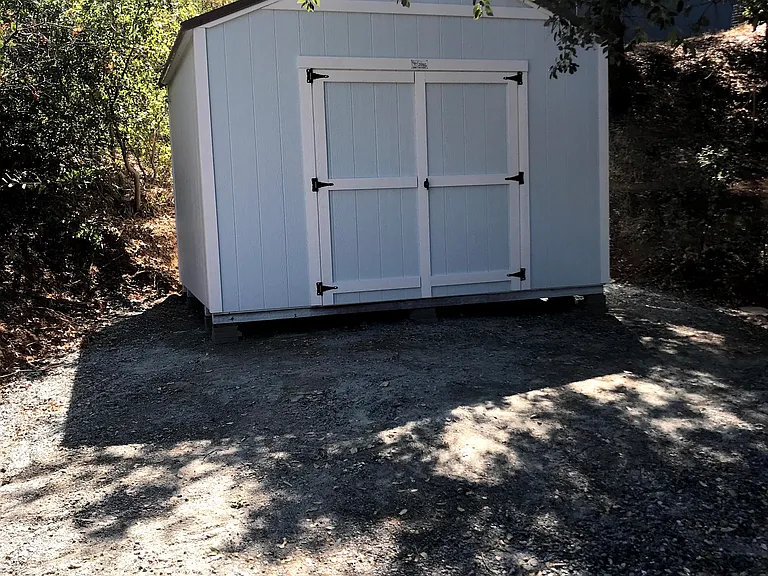 Large Shed and parking pad.