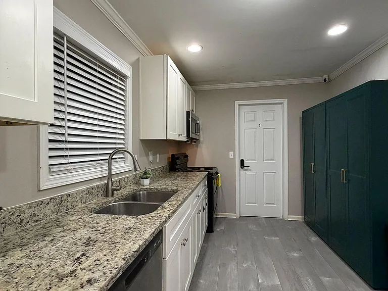 Stone countertops & double sink, plus extra storage with assigned spaces for food and cookware