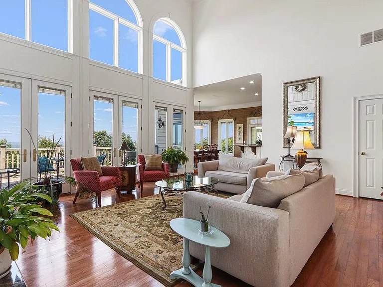 Soaring coffered ceilings in this two story family room featuring a wall of windows