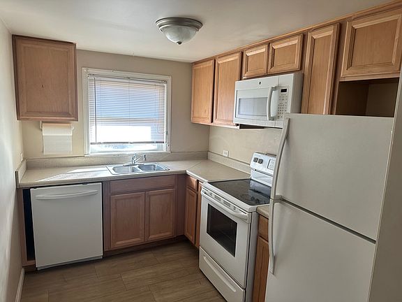 Kitchen with fridge, oven, microwave, and dishwasher