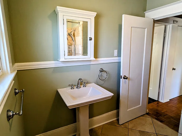 Elegant travertine floor and shower surround.