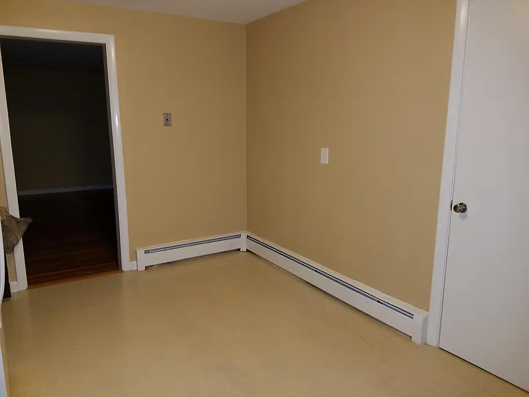 Another view of kitchen showing door to closet and door lead