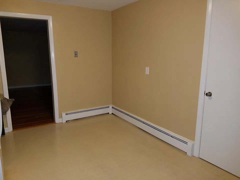 Another view of kitchen showing door to closet and door lead