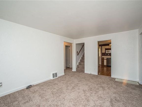 The foyer has a coat closet with hardwood flooring that leads conveniently into the living area.