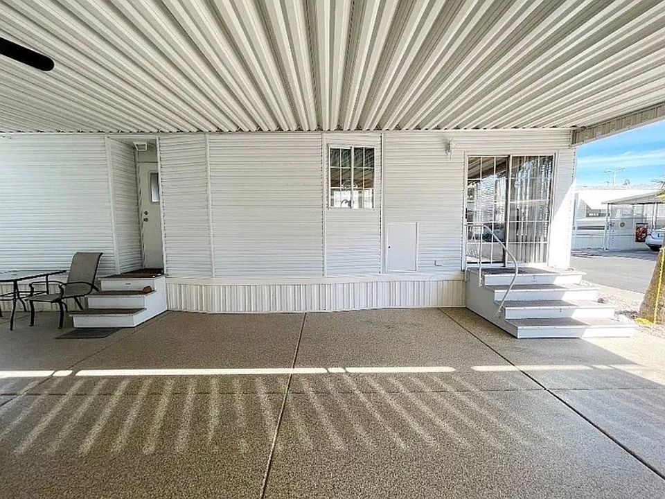 Side of the unit. There are two entrances: a large patio sliding door and a door in the back, leading to the hallway of the unit. This also includes two outside porch lights for easy access to walk up the stairs,