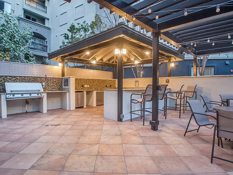 Outdoor kitchen with barbeque grills and picnic seating
