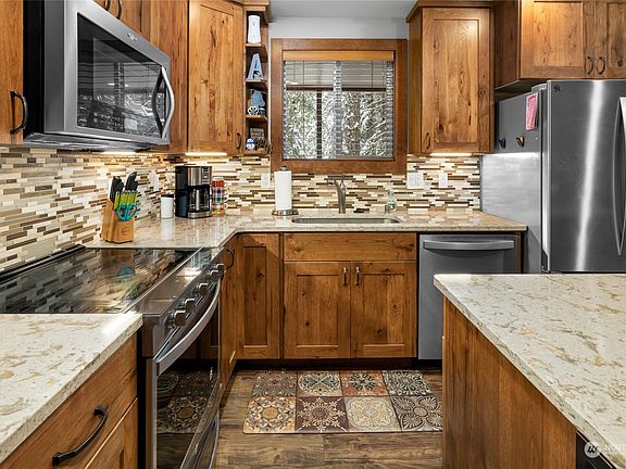 Kitchen window overlooks the covered deck.>