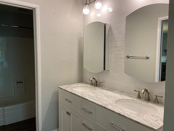 Double marble vanity with extra storage in medicine cabinets