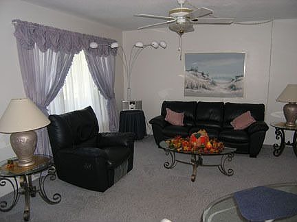 Living room/dining area with TV, leather couch and recliner