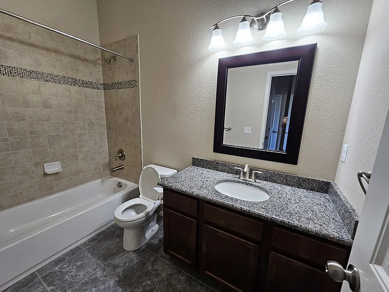 large bath shared by 2nd & 3rd bedroom. granite counter, lots of storage