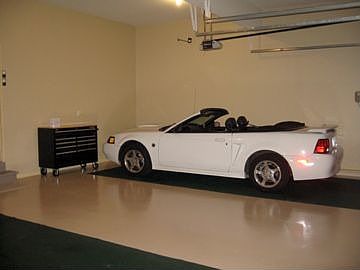 Three car garage with epoxy floor covering and floor mats included