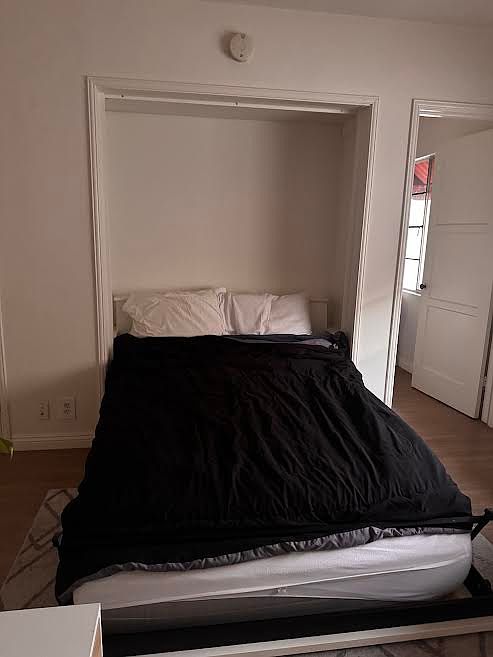 European-style foldaway wall bed; kitchen door; now you see it...