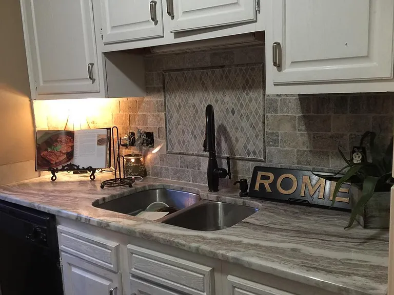 Granite counters and tiled backsplash in select units . . .