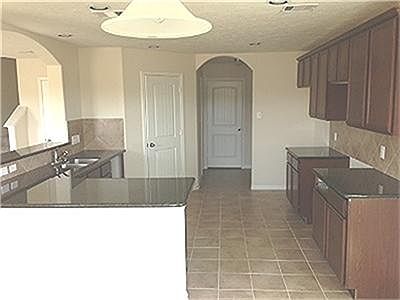  What a great view of your new kitchen with granite counter tops, tile flooring with tile back splash.