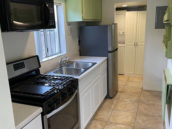 kitchen with new sink and lower cabinets. Stainless steel appliances including new Refrigerator.