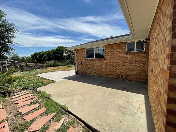 Back yard area with access to garage off patio.