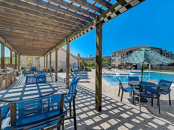 grill area with pergola and outdoor seating
