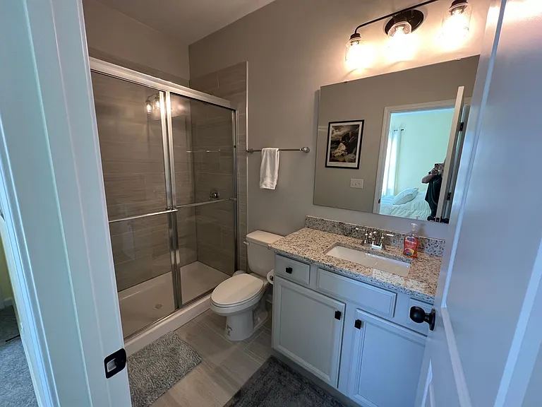 3rd bedroom private bath with walk in shower and granite countertop