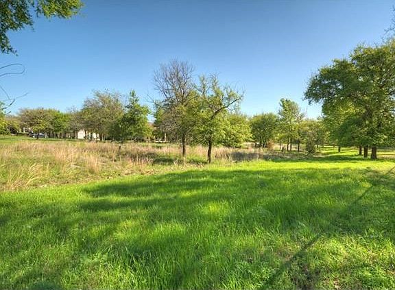 Hugging a wide and pretty nature preserve, this delightful Sun City Texas Brazos Premier Home offers