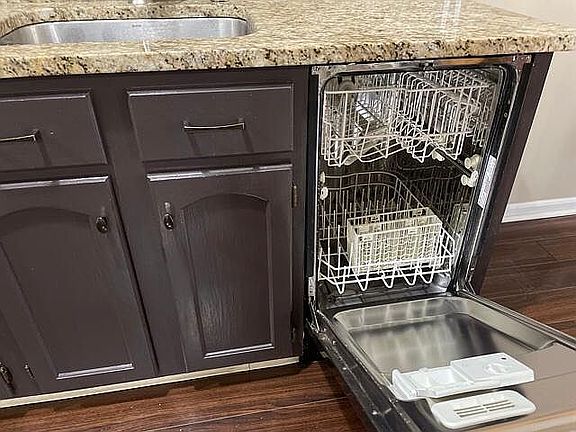 The dishwasher is conveniently located right next to the sink.