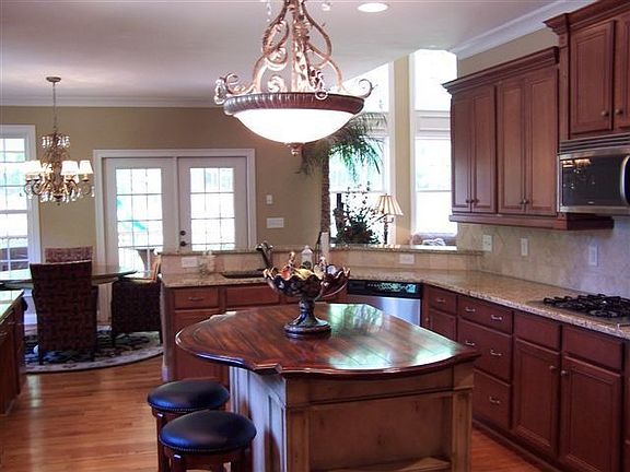 Another view/granite counter tops/ stainless appliances/wine cooler/ island