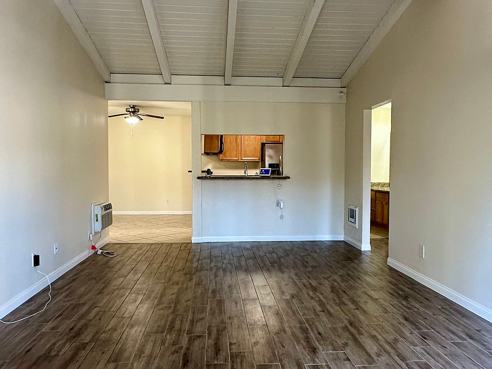 Living area and entry looking towards kitchen. Balcony behind