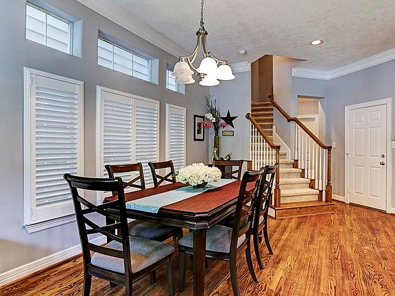 Dining Room just off the Living Room and Kitchen with Crown Molding and custom shutters.