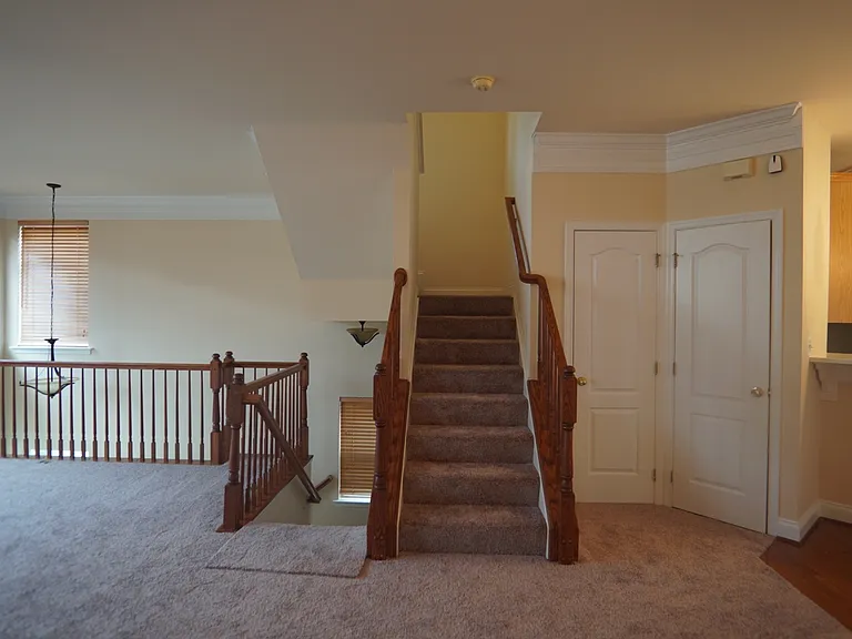 Main living level, coat closet on left, half bath on right