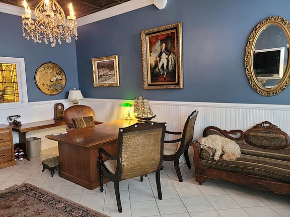 Enter into Front Room Den or Office. Can be closed off from the rest of the house via custom double glass doors and single door to family room. 
*Rescue pup not included!