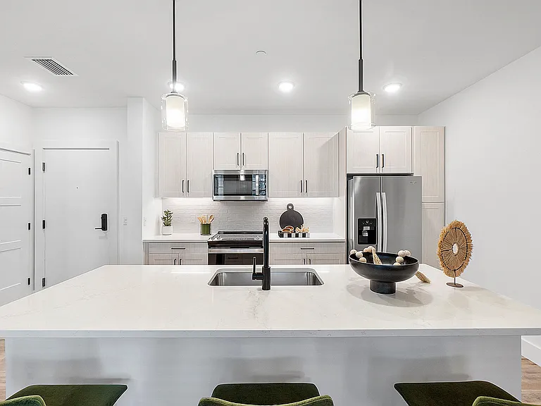 Kitchen island with Quartz Countertops and overhead pendant lighting